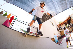 Word Skateboarding day, a boy is standing on a skate